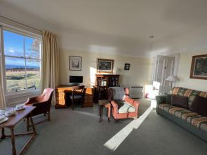 a living room with a couch and a table at Ruddon Grange in Elie