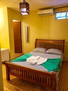 a bedroom with a bed with two towels on it at Pousada Maresia Centro - Piscinas Naturais in Porto De Galinhas
