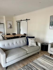a living room with a couch and a table at High Country Holiday Park in Mansfield