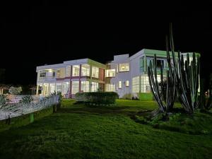 a large house at night with lights on at Finca tres colinas in Lemos
