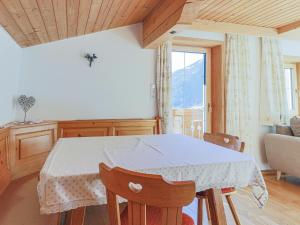 a table and chairs in a room with a window at Boar Hof Top 1 in Kirchberg in Tirol