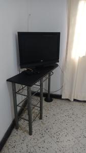 a television sitting on a table in a room at Hotel Villa Mary Apartaestudios playa in Puerto Colombia