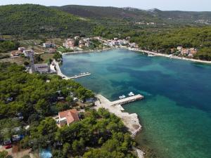 an aerial view of a lake with a dock at Double Room Pasman 4309e in Pašman