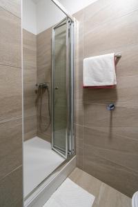 a shower with a glass door in a bathroom at Double Room Pasman 4309e in Pašman