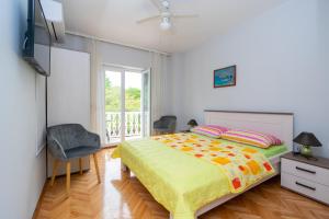 a bedroom with a large bed and a window at Rooms by the sea Pasman - 4309 in Pašman