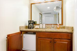 a bathroom with a sink and a mirror at 256 Sandcastles - Hotel Side in Fernandina Beach