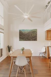 a dining room with a table and a ceiling fan at Puamana Maluhia - Two Bedroom / Two Bath Condo in Princeville