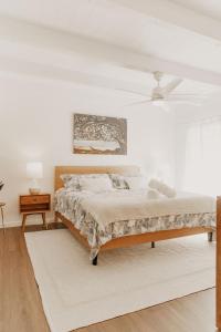 a white bedroom with a bed and a white ceiling at Puamana Maluhia - Two Bedroom / Two Bath Condo in Princeville