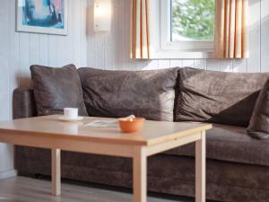 a brown couch with a coffee table in a living room at 4 person holiday home in GROEMITZ in Grömitz