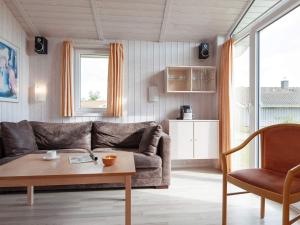 a living room with a couch and a table at 4 person holiday home in GROEMITZ in Grömitz