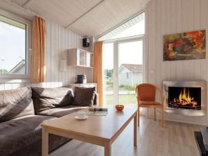 a living room with a couch and a fireplace at 4 person holiday home in GROEMITZ in Grömitz