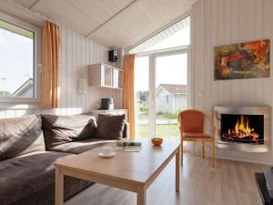 ein Wohnzimmer mit einem Sofa und einem Kamin in der Unterkunft 4 person holiday home in GROEMITZ in Grömitz