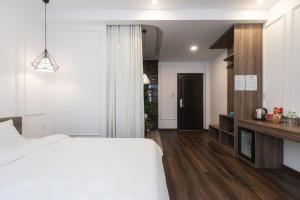 Postel nebo postele na pokoji v ubytování MSing DaLat Hotel
