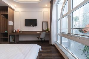 Postel nebo postele na pokoji v ubytování MSing DaLat Hotel