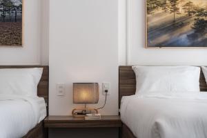 Postel nebo postele na pokoji v ubytování MSing DaLat Hotel