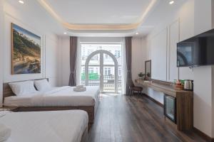 Postel nebo postele na pokoji v ubytování MSing DaLat Hotel