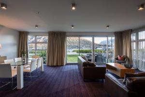 a living room with a couch and a table at Marina Apartments - Element Escapes in Queenstown