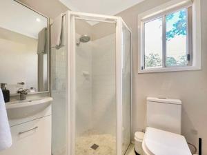 a bathroom with a shower and a toilet and a sink at Tallowood House in Nulkaba +19 photos