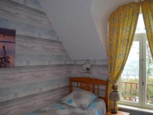 a bedroom with a wooden accent wall and a bed at Gîte à Saint-Étienne-au-Mont avec jardin privatif, cheminée, WiFi et animaux admis - FR-1-376-77 in Saint-Étienne-au-Mont +9 photos
