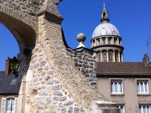 a building with a domed tower in the background at Gîte à Saint-Étienne-au-Mont avec jardin privatif, cheminée, WiFi et animaux admis - FR-1-376-77 in Saint-Étienne-au-Mont