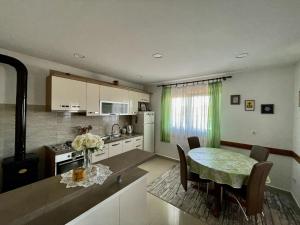 a kitchen and dining room with a table and a dining room at Apartments Veli Rat in Veli Rat