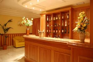 a lobby with a bar with bottles of wine at Hotel Joyfull in Naples