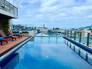 a swimming pool on the roof of a building at Centro One Patong in Patong Beach