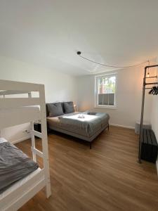 a bedroom with a bed and a bunk bed at Apartmenthaus Stade Schwingewiesen Apartment 7 in Stade