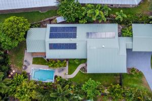 an overhead view of a building with solar panels and a pool at Mango Wood Villa Tropical Coastal living in Clifton Beach