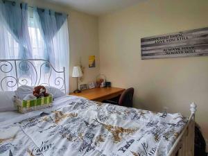 a bed with a basket with a teddy bear in it at 5 star Room/Close to town center and everything/5 min walk metro in Rockville