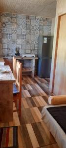 a kitchen with a refrigerator and a table with chairs at José María in Melipeuco