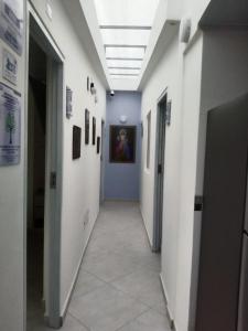 a hallway in a hospital with a painting on the wall at Casa Jac in Bucaramanga