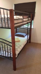 a couple of bunk beds in a room at Port Waikato Holiday Park in Port Waikato