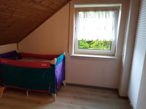 a small room with a bed and a window at Ferienhaus Happel in Bad Endbach