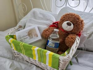a teddy bear in a basket with a bottle of water at 5 star Room2/Close to everything/5 min walk metro/Rockville Town Center in Rockville