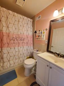 a bathroom with a toilet and a sink and a mirror at 5 star Room2/Close to everything/5 min walk metro/Rockville Town Center in Rockville