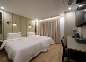 Voodi või voodid majutusasutuse Ocean city hotel toas