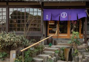 a building with a purple banner on the front of it at Ryokan Kiraku in Beppu