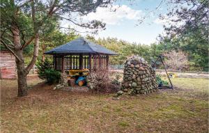 a small gazebo with a boy sitting in it at 2 Bedroom Cozy Home In Pasym in Pasym