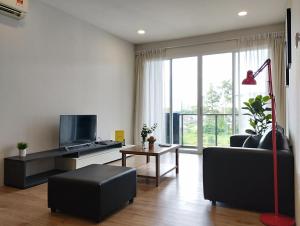 a living room with a couch and a tv at Urban ONE Homestay 8pax 3Rooms in Kuching