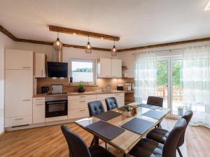 a kitchen and dining room with a table and chairs at Haus Hüttenberger in Going am Wilden Kaiser