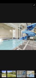 a large swimming pool with a blue slide at Canmore Mountain Retreat. Hot Tub, Pool, King Bed! in Canmore