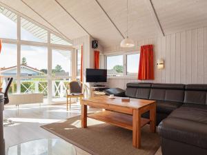 a living room with a couch and a table at Three-Bedroom Holiday home in Grömitz 13 in Grömitz