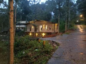 a house that is sitting on the side of a road at Kodai Elegance in Kodaikānāl