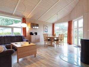 a living room with a couch and a table at Three-Bedroom Holiday home in Grömitz 11 in Grömitz