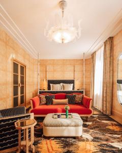 a living room with a red couch and a chandelier at Sommerro in Oslo