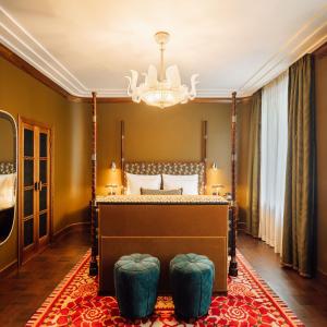 a bedroom with a canopy bed and a chandelier at Sommerro in Oslo