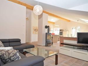 a living room with a couch and a tv at Residenz Margarete - Penthouse 2.7 in Binz