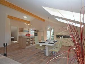 a kitchen and dining room with a table and chairs at Residenz Margarete - Penthouse 2.7 in Binz