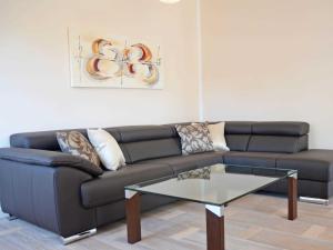 a living room with a couch and a glass table at Residenz Margarete - Penthouse 2.7 in Binz